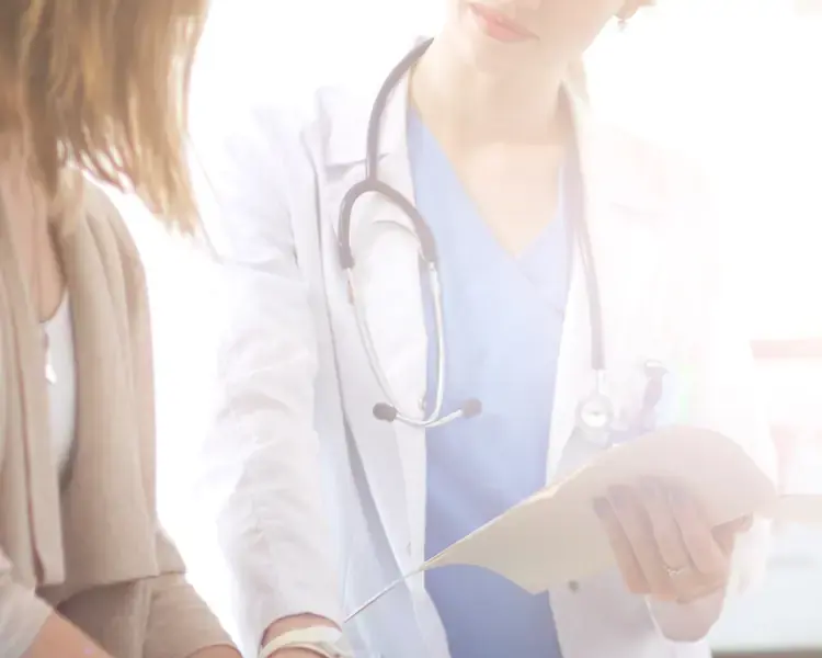 Physician reviewing notes with a patient during a lipoma consultation, Power Plastic Surgery Toronto