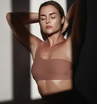 Woman in a tan top, representing the in-person consultation